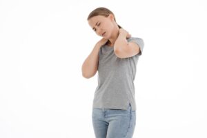 Picture of a woman holding her neck in pain
